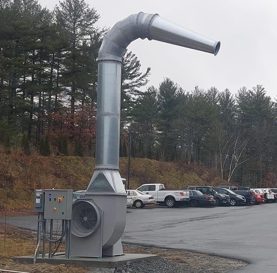 Fleet Blast snow removal unit with fan, control panel and angled air duct installed beside a parking lot